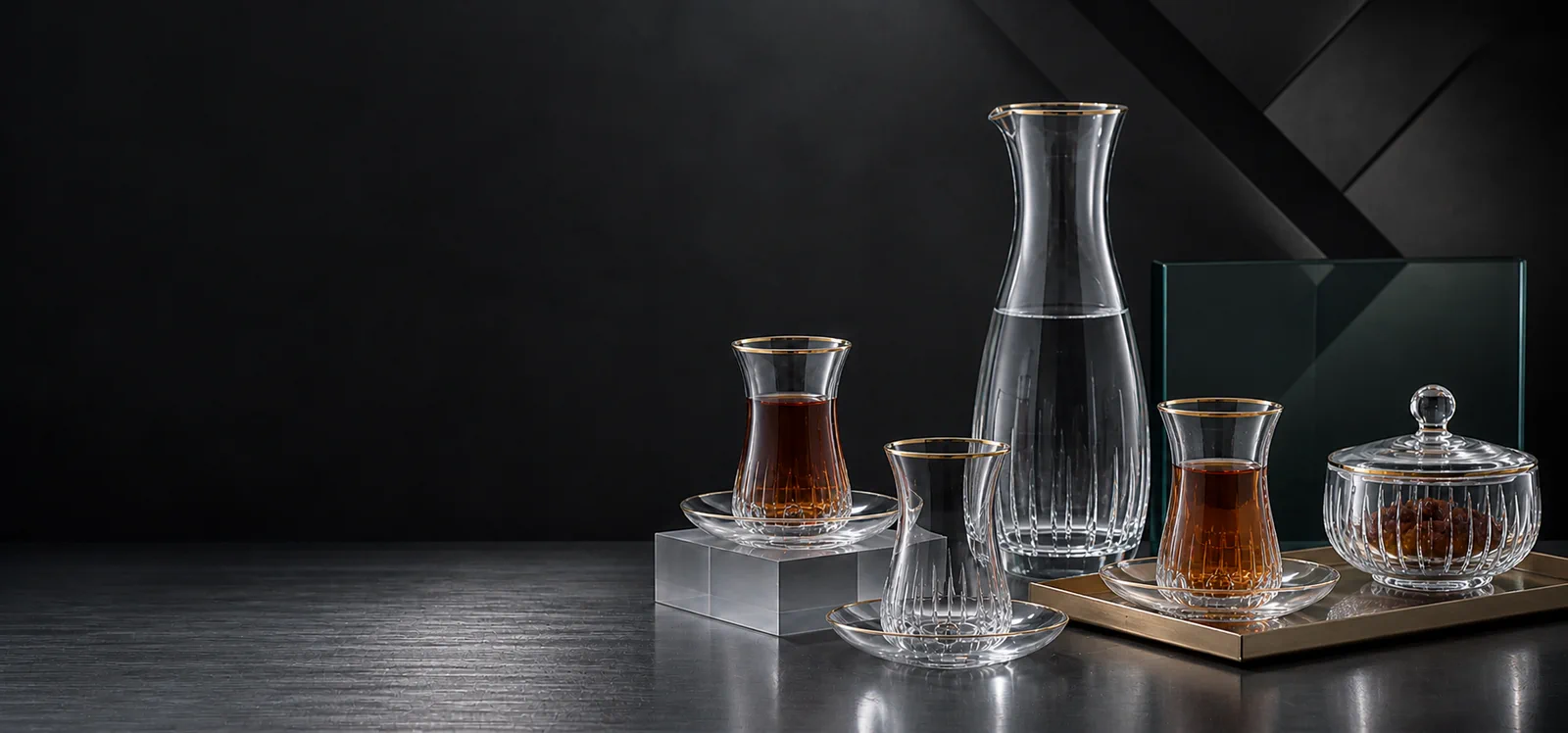 Conceptual hospitality setting with Middle Eastern tea glasses, carafe and dates